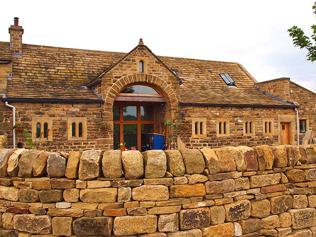 completed barn conversion with stone wall, eldwick, west yorkshire