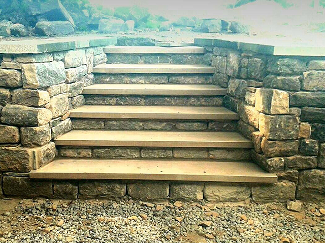 custom stonework retaining wall and steps